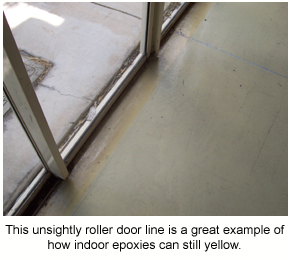 Yellowing of an indoor epoxy underneath the roller door line located inside sliding glass doors.