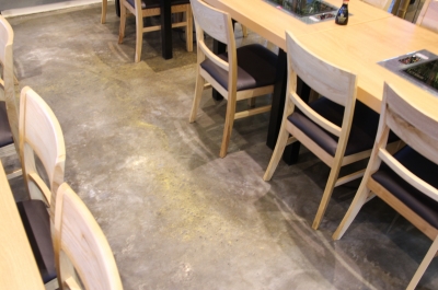 A photo looking down on the metallic epoxy floor in the seating area, showing the gold highlights used to match the Korean decor.