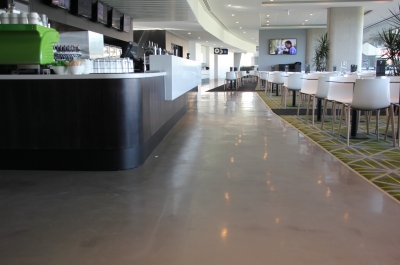 A picture of the Adelaide Oval bar showing the glossy decorative epoxy floor stretching across the large bar and along a hallway.