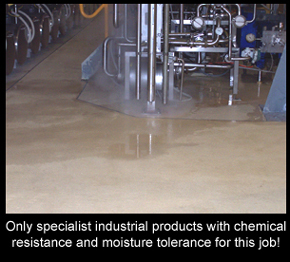 Industrial resin flooring in chemical plant with water on surface.