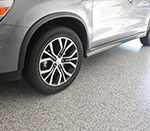 Flake floor in a residential garage with car parked on top.
