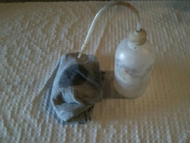 A squirter bottle and rag used for cleaning up epoxy resins.