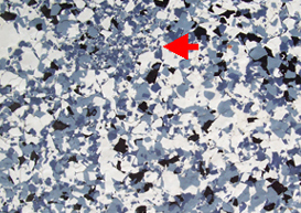 A close-up photo of a flake floor showing the clumping of fine flake particles that can be undesirable.