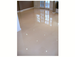 A high-gloss epoxy floor in a living room that would benefit from using a polish to protect it from scratching and scuffing.