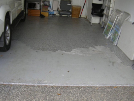 A flaking floor in a garage that would need to be removed rather than over-coated.