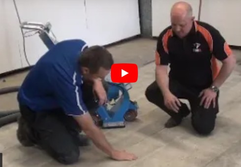 Resin Jack inspecting a concrete slab after it had been prepared with a shot blaster.