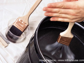 Brushes being cleaned in a bucket of water after application of a water-borne epoxy coating.