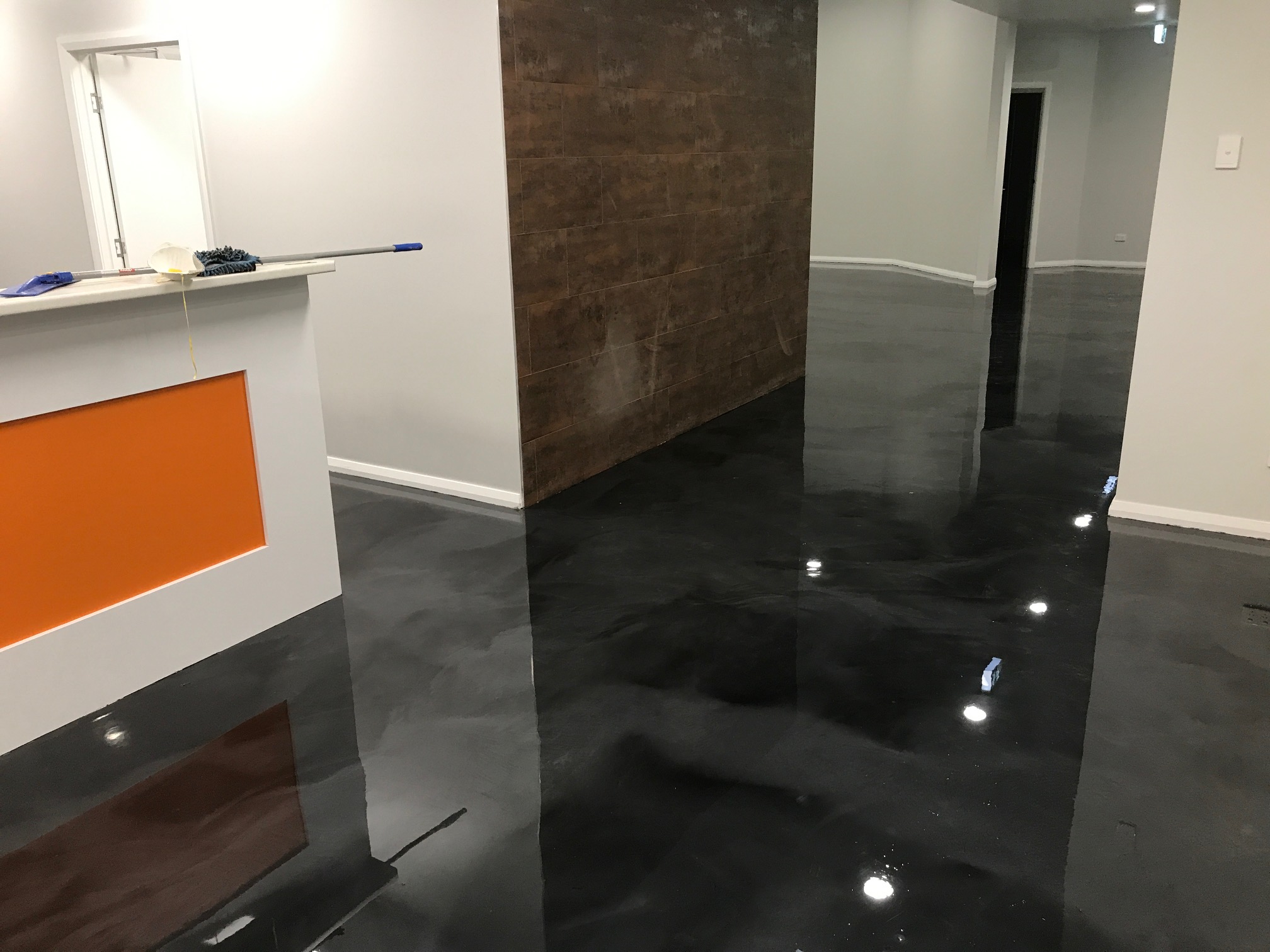 A black metallic decorative floor installed in the airport facility of a remote town.