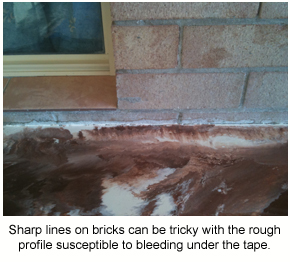 Epoxy flooring applied next to brickwork showing how hard it can be to get sharp lines on the rough surface.