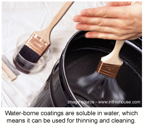 Brushes being cleaned in a bucket of water after application of a water-borne epoxy coating.