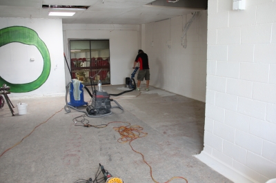 Surface preparation being conducted in the office before the decorative epoxy floor was installed for the charity organisation.
