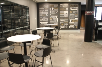 Adelaide Oval club room with tables and chairs on top of the installed decorative epoxy floor.