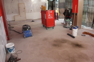 The empty restaurant and bare concrete floor before the decorative epoxy floor was installed.