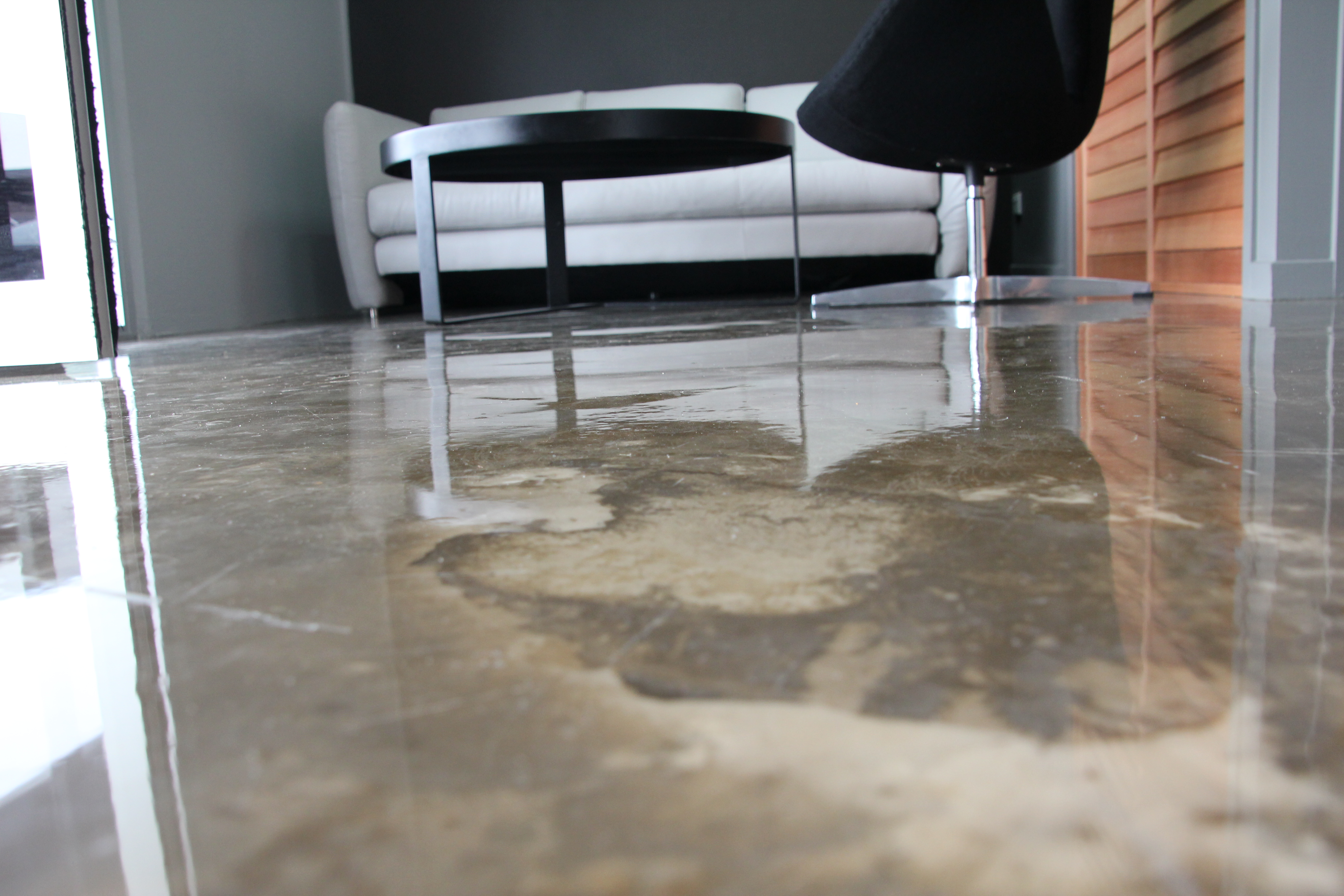 A low-angle photo of the decorative epoxy flooring in the waiting room, highlighting the stone-like pattern and glossy finish.