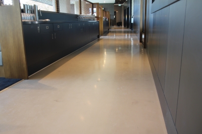 A picture of the Adelaide Oval restaurant showing the glossy decorative epoxy floor and the cabinets that line the long hallway.