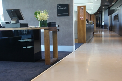 A picture of the Adelaide Oval restaurant showing the glossy decorative epoxy floor curling around a long hallway.