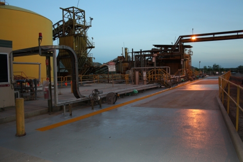 Concrete aprons and drains of uranium mine coated with industrial epoxy flooring. 