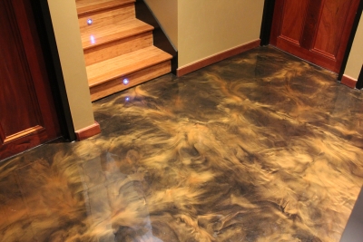 The entry to the apartment showing the gold metallic floor and stairs that lead up to the second floor.