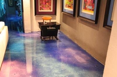 The cosmic-looking metallic epoxy floor worked beautifully with the games room, including this old arcade machine.