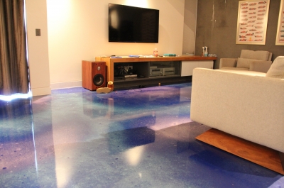 The cosmic-looking metallic epoxy floor worked beautifully with the games room, including the TV and entertainment area.