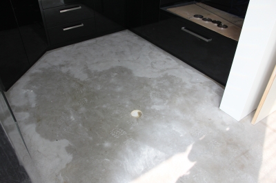The uncovered concrete in the laundry before the metallic epoxy floor was installed.