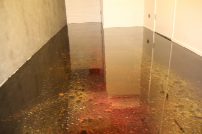 Another angle of the volcanic metallic epoxy floor in the residential wine cellar.
