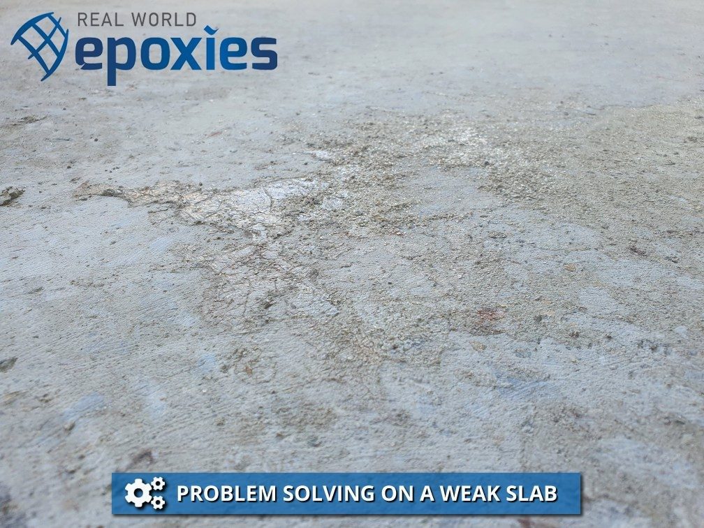 A weak slab with crystals on the surface from a product used to densify the concrete.