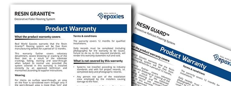 Two hard copies of resin flooring system warranties lying on top of each other.