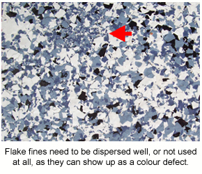 A close-up photo of a flake floor showing the clumping of fine flake particles that can be undesirable.