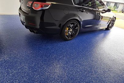 A blue epoxy floor in a residential garage.