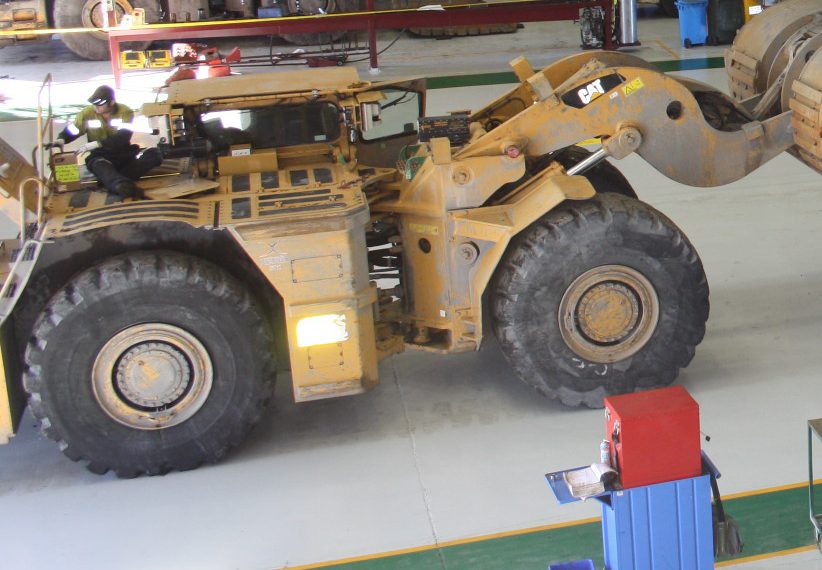 A non-slip epoxy flooring with a large mining vehicle parked on top.