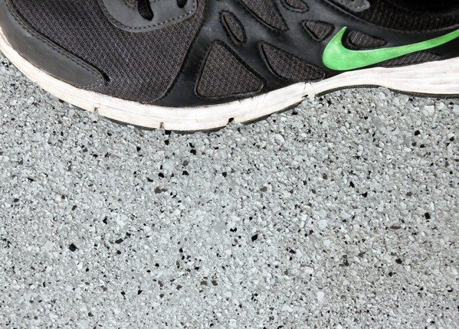A close-up photo of a person's shoe walking across a Resin Granite floor.
