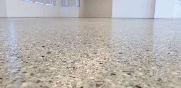 A close up, low-angle shot of a garage floor showing the Resin Granite finish.
