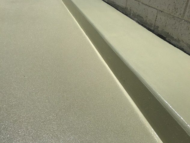 A close up view of Resin Grip used on the trafficable sections of a chemical containment bund.