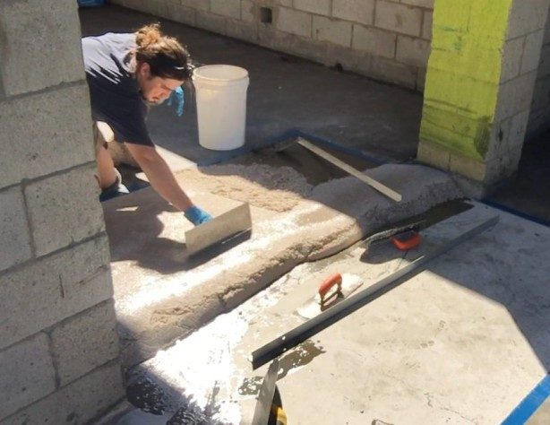 A ramping compound using Ezypoxy Clear as the binder being trowelled into place in a factory.