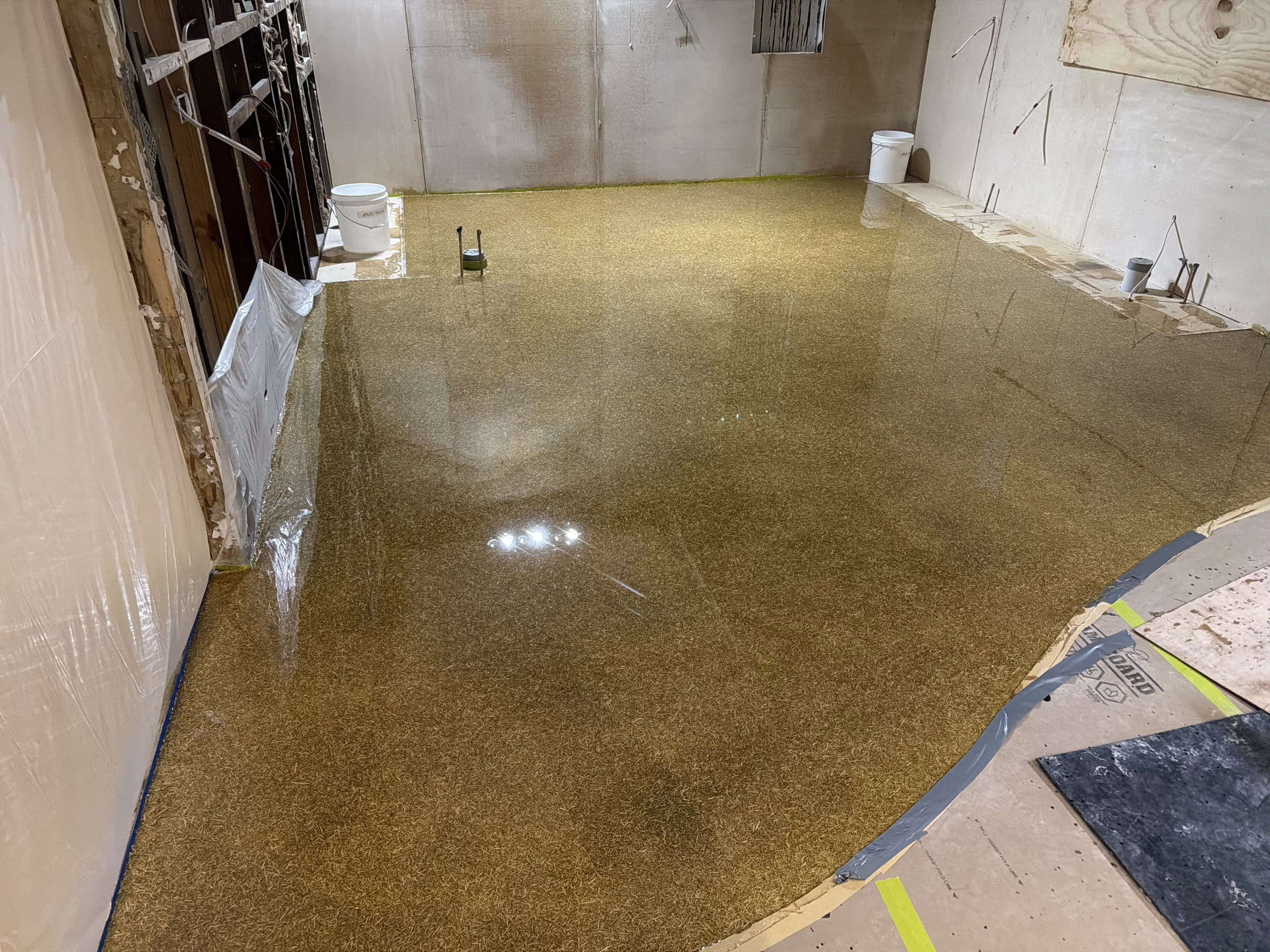 A low angle shot of the vibrant signal red non-slip epoxy floor showing the aggressive non-slip texture required in the abattoir.