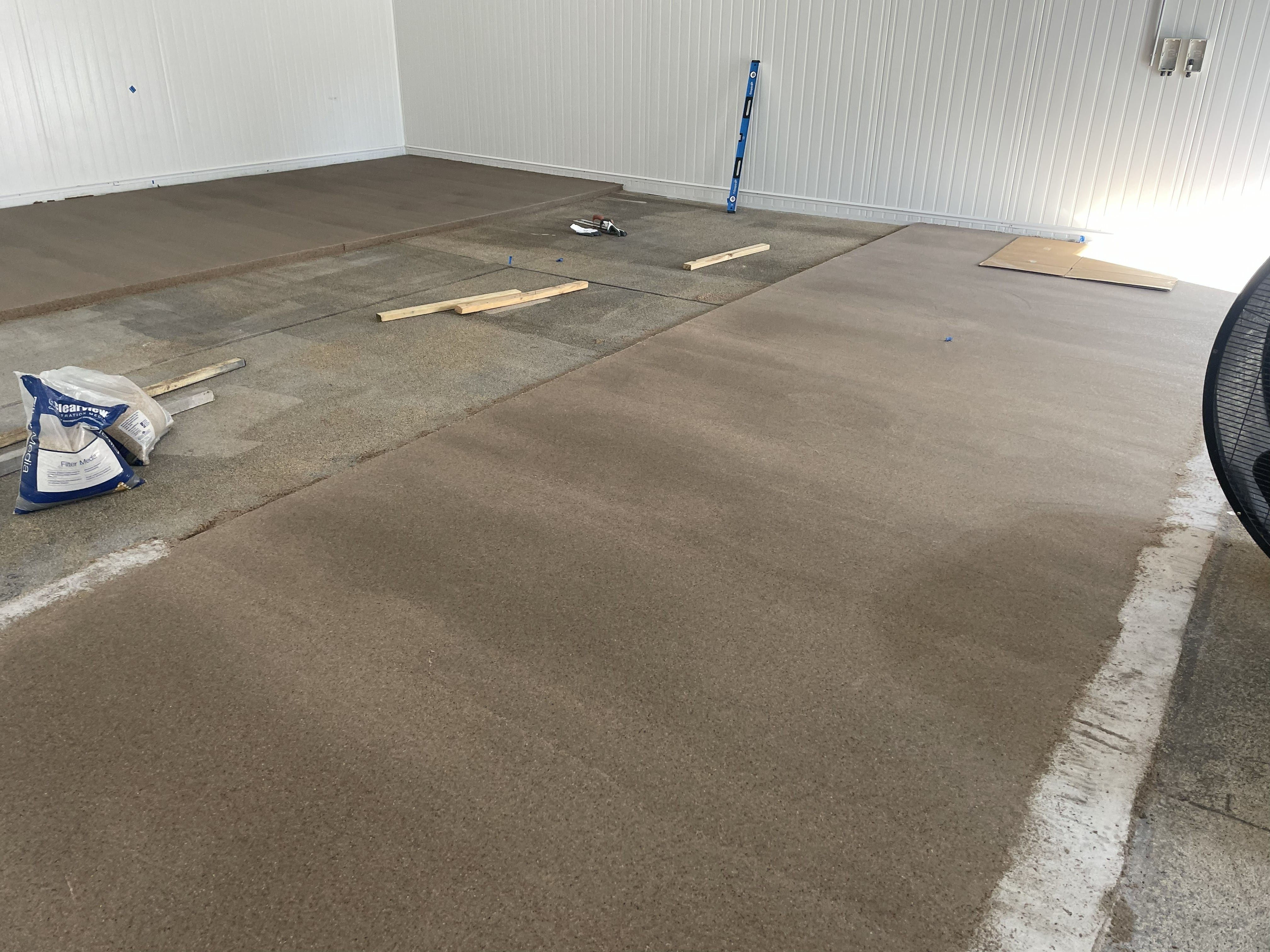 A low angle shot of the vibrant signal red non-slip epoxy floor showing the aggressive non-slip texture required in the abattoir.