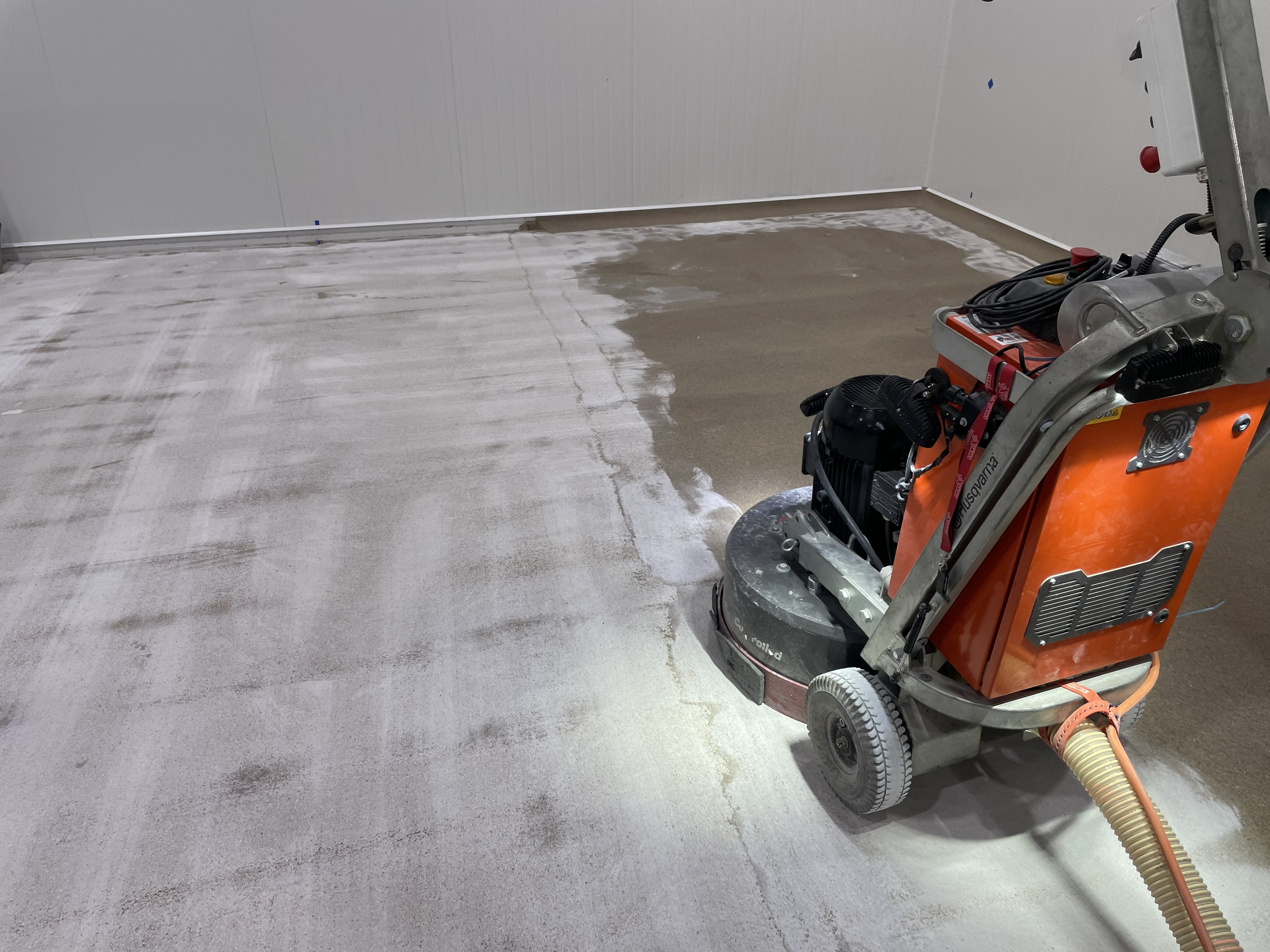 A low angle shot of the vibrant signal red non-slip epoxy floor showing the aggressive non-slip texture required in the abattoir.