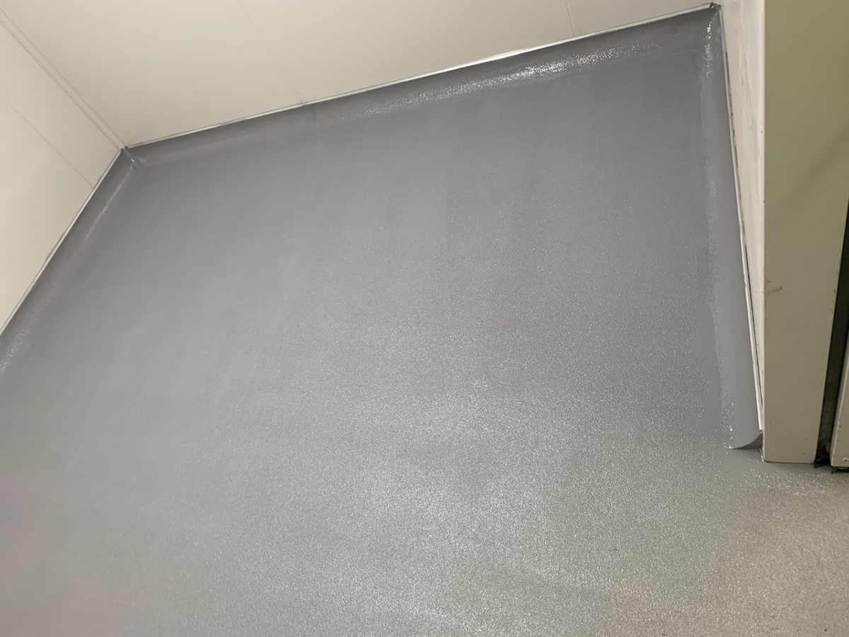 A train waiting to enter a workshop where the Jaxxon industrial coatings were used to create a durable, non-slip floor.