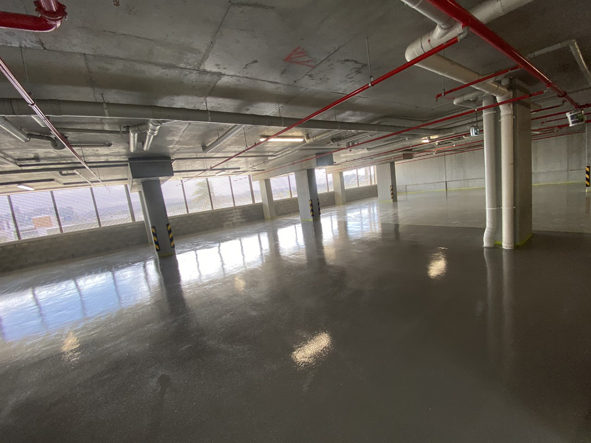 A low-angle shot of a floor in a commercial kitchen showing the texture of the non-slip finish.