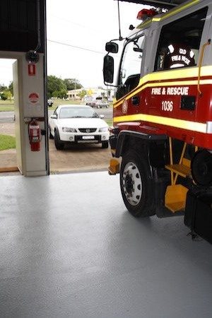 A fire truck in a fire station parked on a non-slip floor that used Jaxxon 1505.
