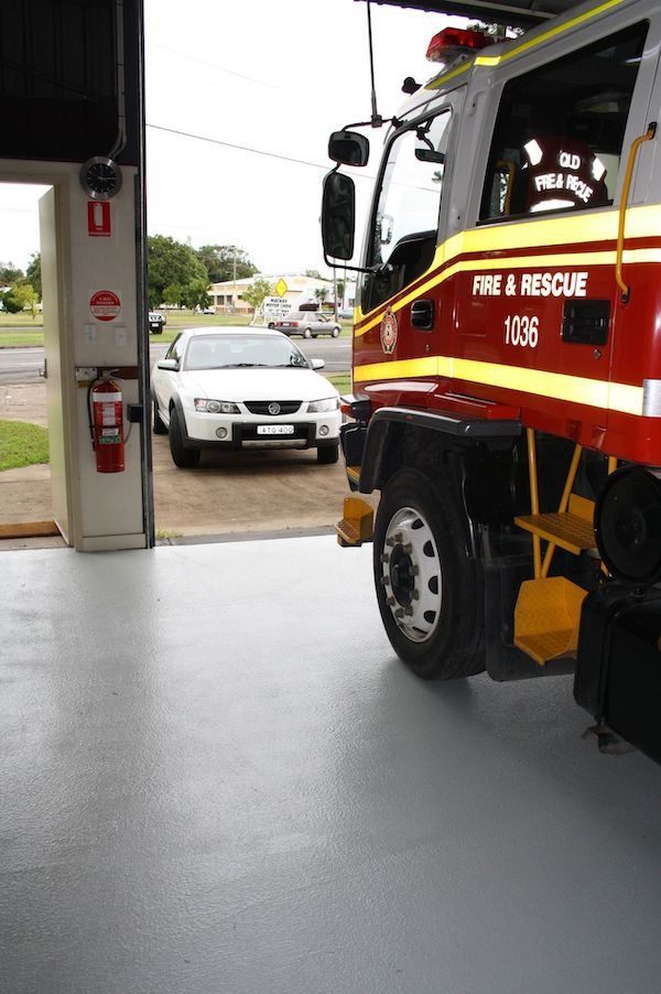 Jaxxon 1505 non-slip floor in a fire station with a fire truck parked on top.