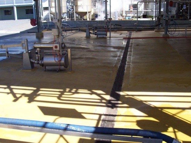 A truck filling station with a custom-coloured Jaxxon 1525 non-slip flooring applied across the area.