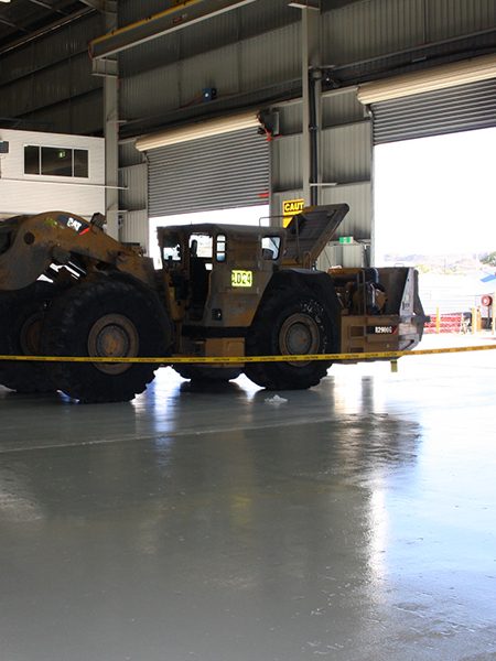 Jaxxon 1525 used in a workshop with heavy mining machinery parked on top.