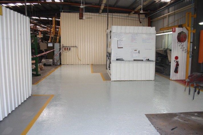 A factory with Jaxxon 1525 applied onto the floor for protection and line marking purposes.