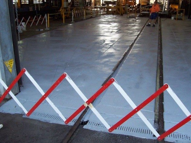 A section of railway workshop being cordoned off following the application of a Jaxxon 1525 non-slip floor.