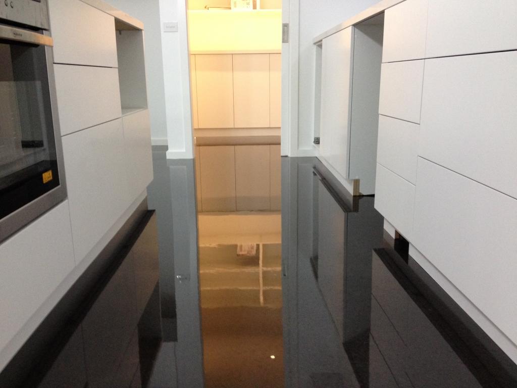 Artepoxy Liquid Crystal used to create a glossy black floor in a ultra-modern residential kitchen.