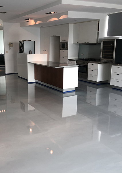 Artepoxy Liquid Marble used to create a glossy iron grey floor in a ultra-modern residential kitchen.