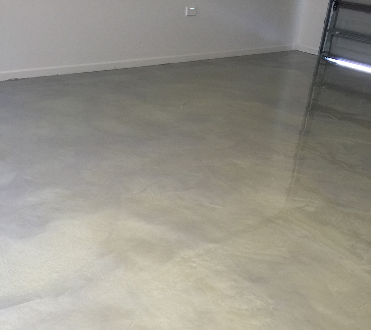 A photo from the back of a residential garage with door closed to show the gorgeous marble pattern created by Artepoxy Liquid Marble.