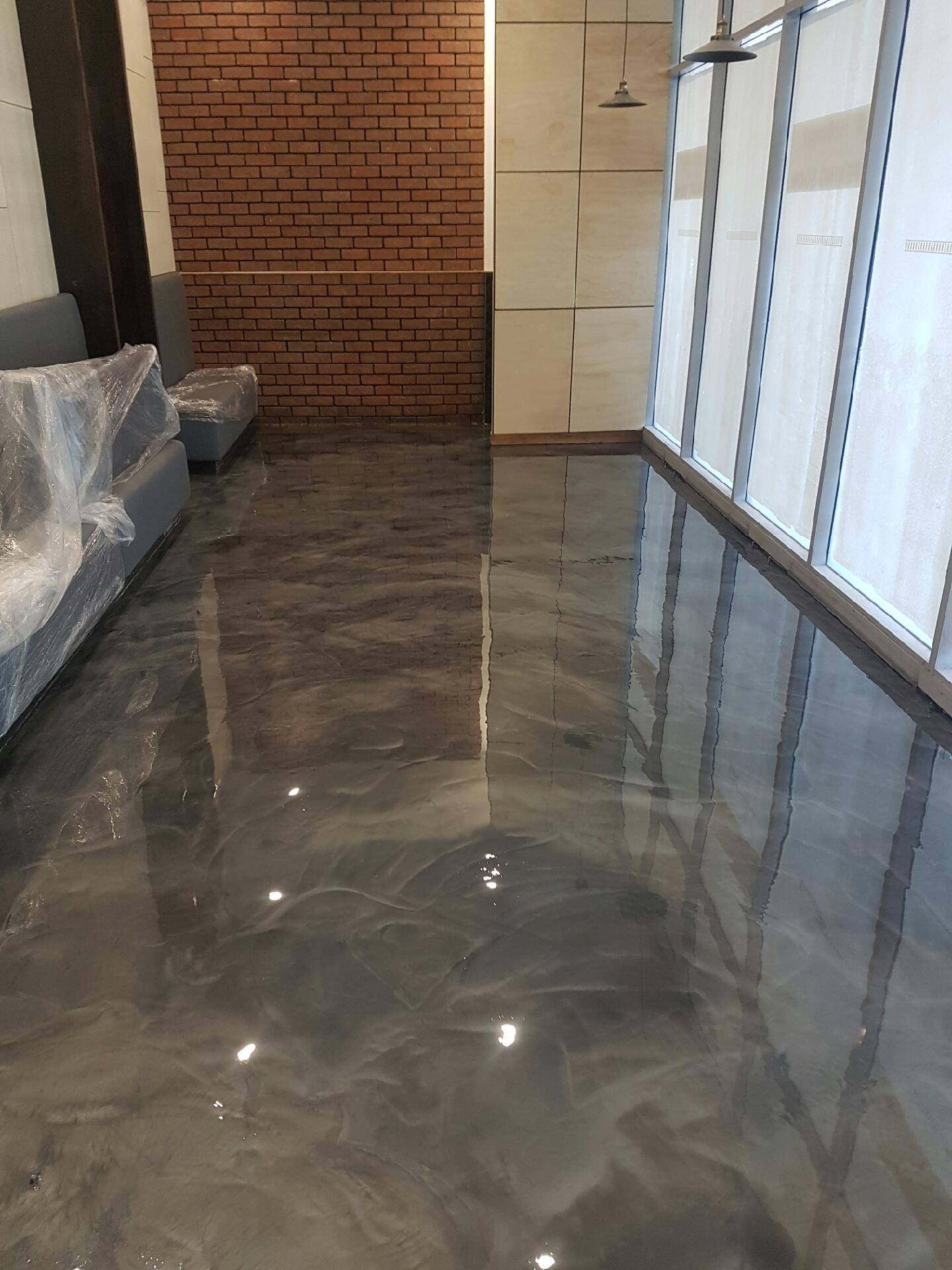 Artepoxy Liquid Marble used to create a dark grey metallic floor in a restaurant eating area.